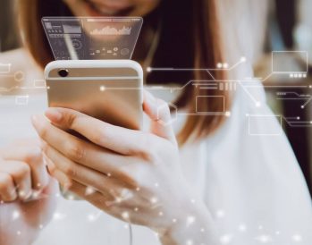 woman holding cell phone with 3D holograms