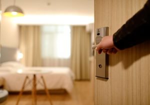a corporate traveler checking in to their boring chain hotel before small businesses got smart in marketing to business travelers