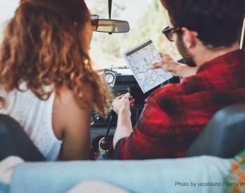 couple sitting in car looking at their road map