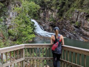 Woman standing admiring Tallulah Gorge waterfalls