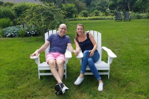 two people sitting on front lawn at candleberry inn
