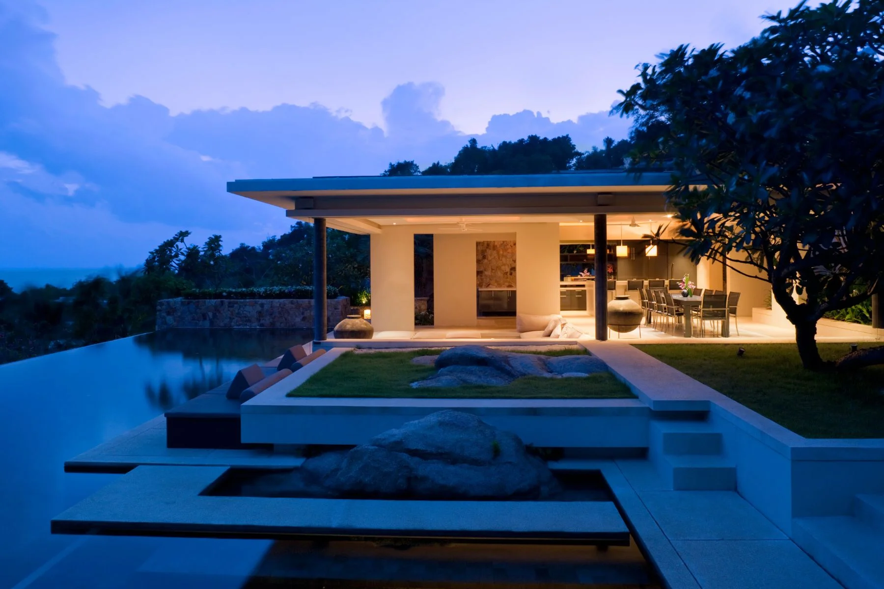 nighttime vacation rental home with pool and outdoor living space