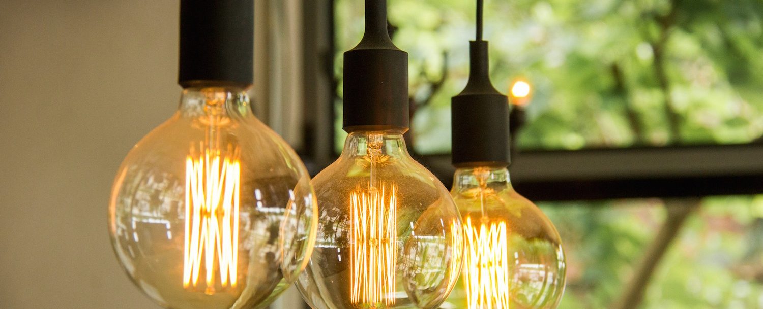 Glowing retro light bulbs hanging from ceiling
