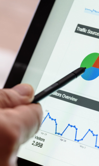 Pointing at graph on Google Analytics, researching keywords for SEO