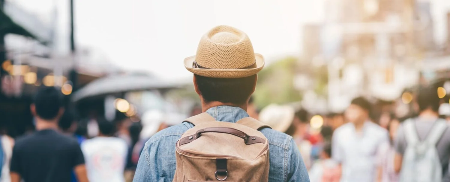man with backpack traveling after booking a vacation rental with our marketing tips