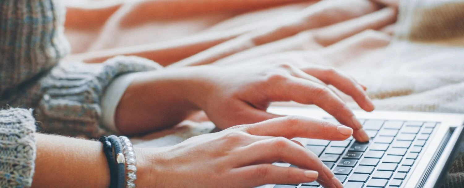 woman typing on the computer