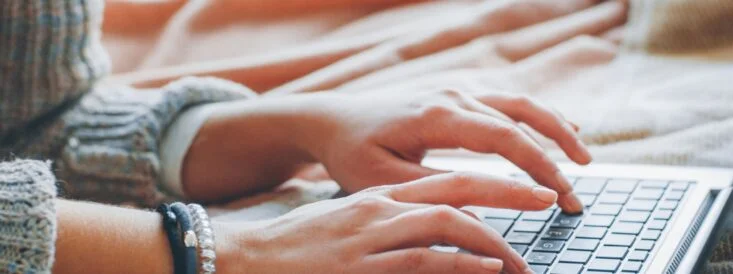woman typing on the computer